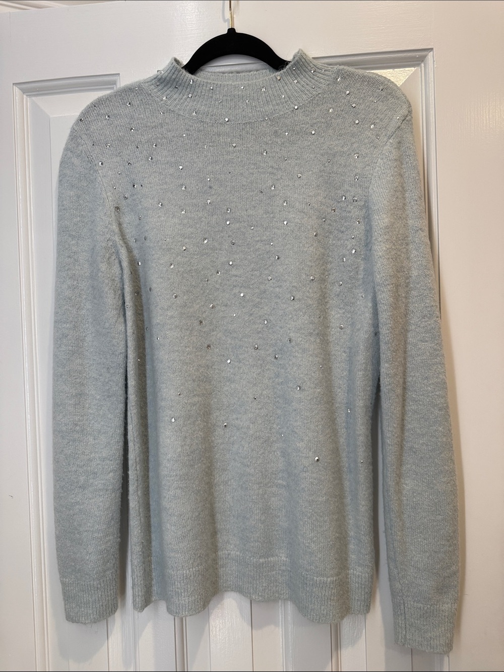 Cream V-Neck Sweater with Rhinestone Bow Detail can be worn off the shoulder med